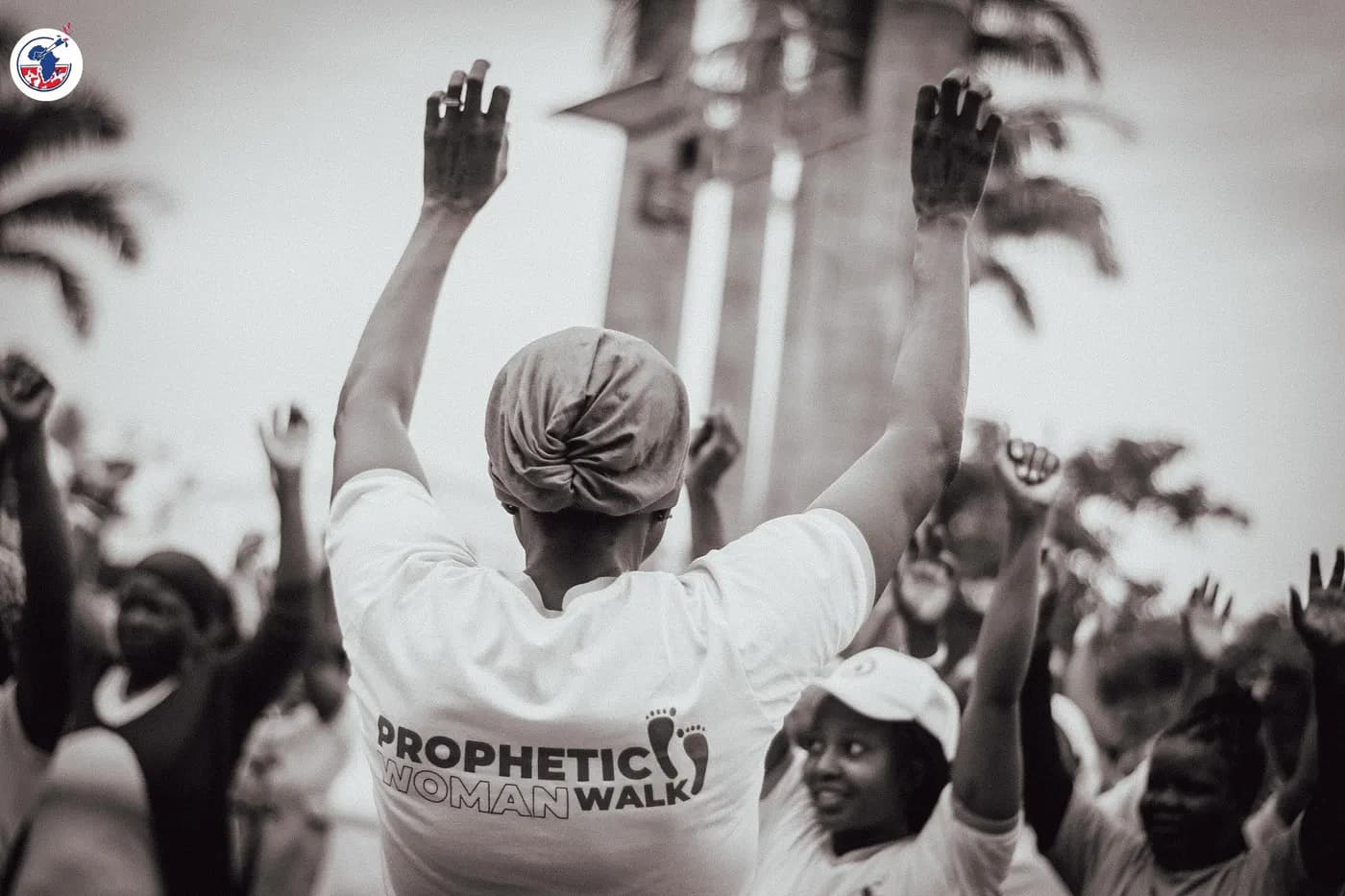 Women on the Prophetic Walk with hands raised.