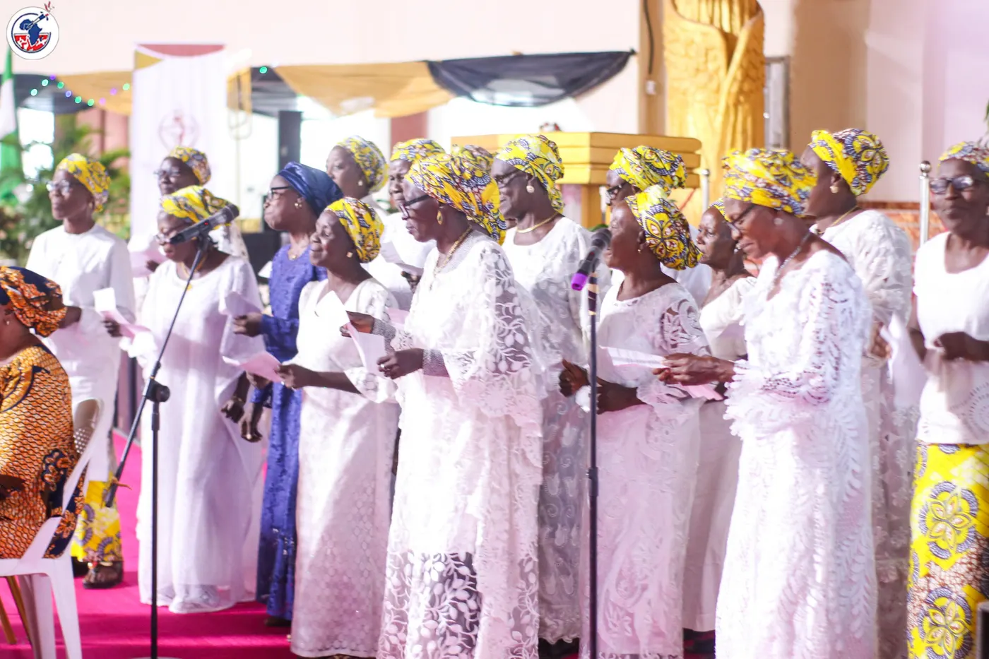 The choir leading worship in white.