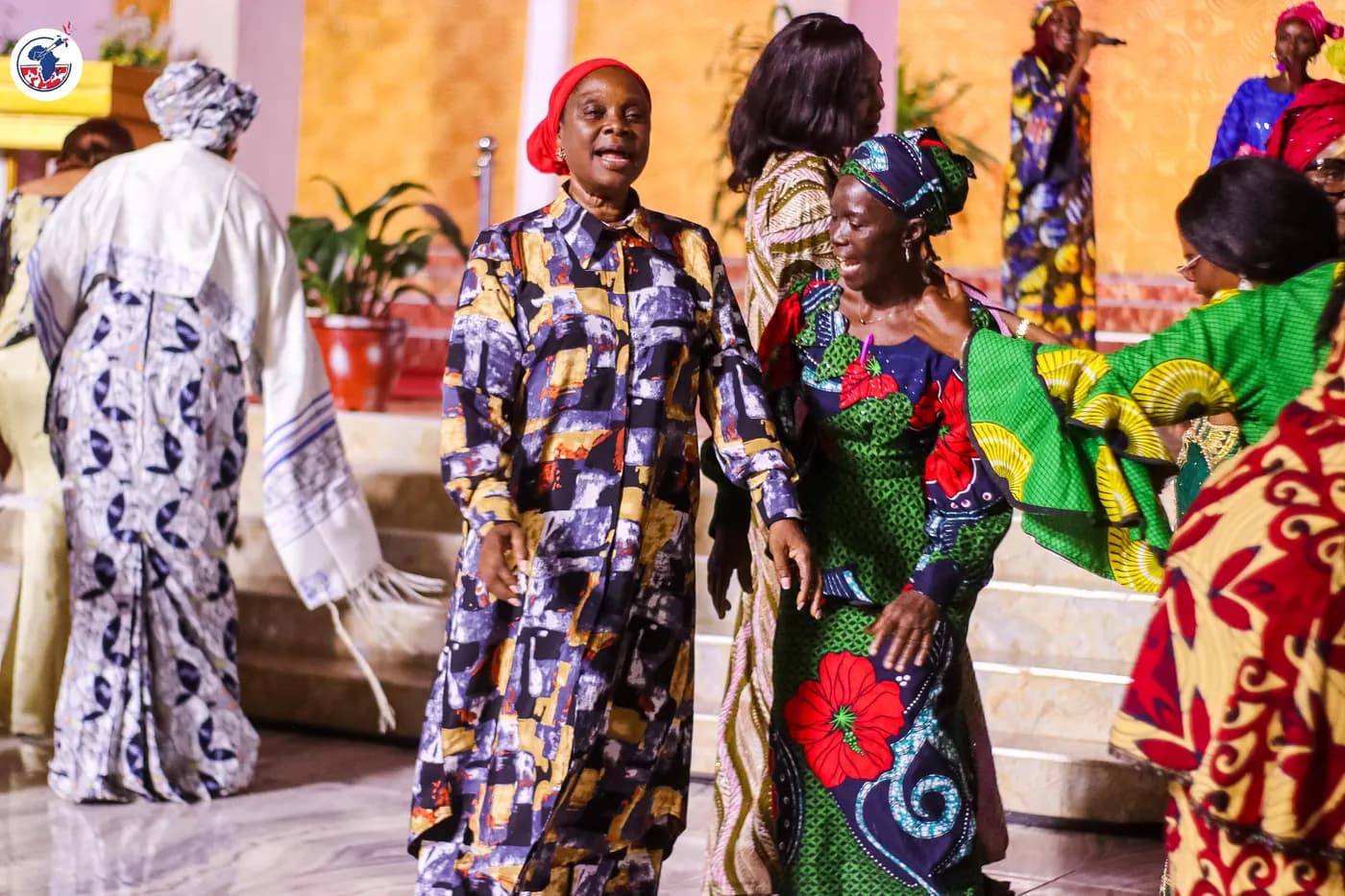 Women of the Alliance in procession in celebration attire.