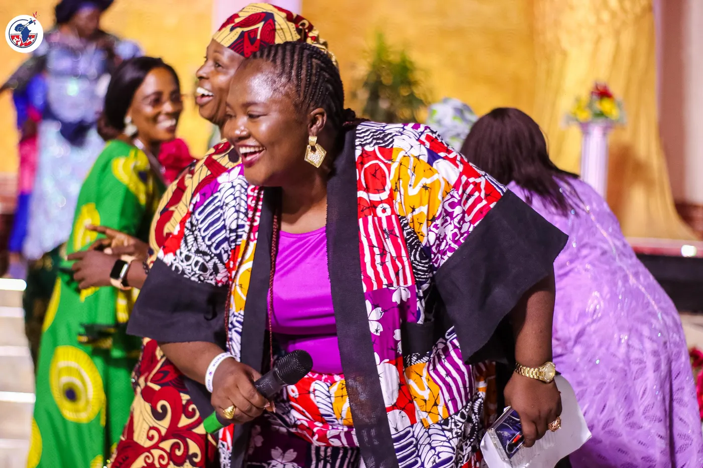 Women greeting one another in celebration at the anniversary.