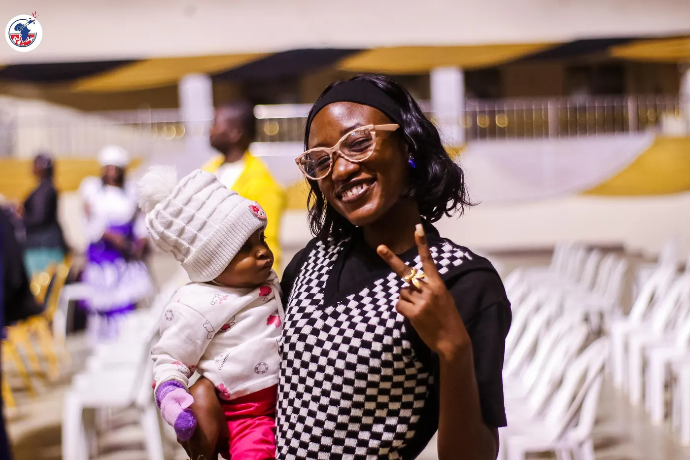 A mother holding her child during the gathering.